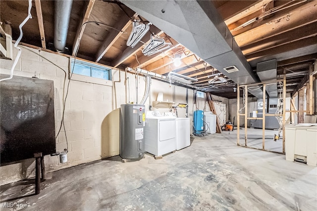 basement with electric water heater and washer and clothes dryer