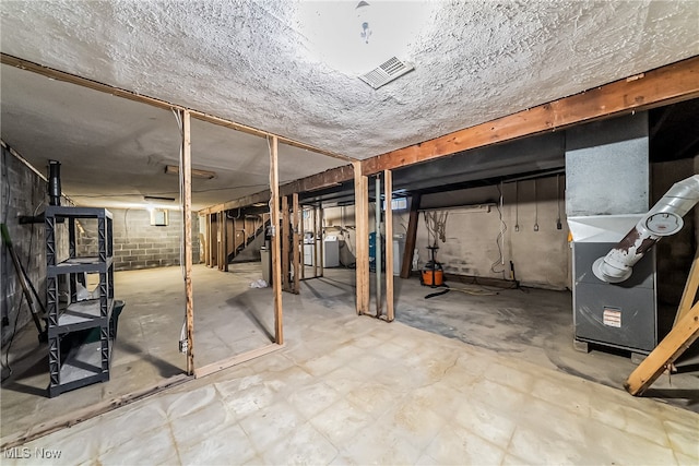 basement with washer / dryer and heating unit