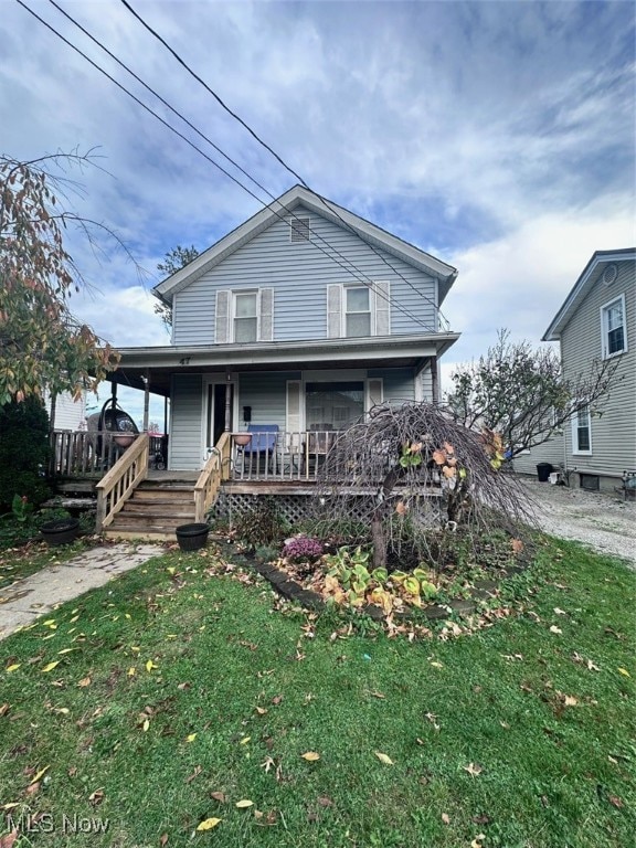 view of front of house featuring covered porch and a front lawn