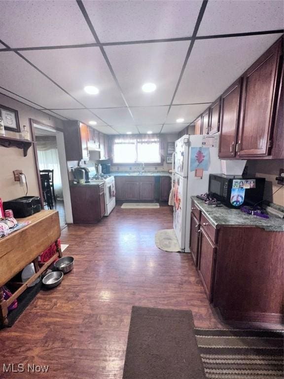 47 Swan St, Geneva, OH 44041 - kitchen featuring dark wood-style floors, white gas stove, recessed lighting, dark brown cabinetry, and black microwave