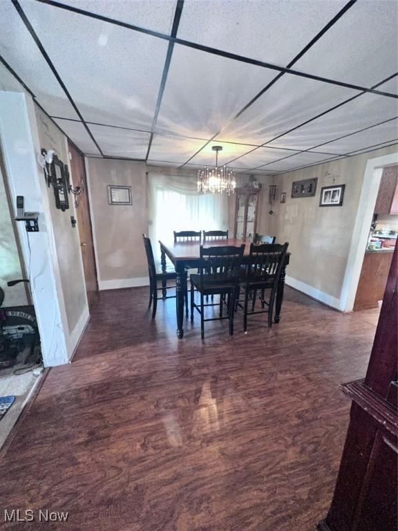 47 Swan St, Geneva, OH 44041 - dining room with a notable chandelier, baseboards, and dark wood-style floors