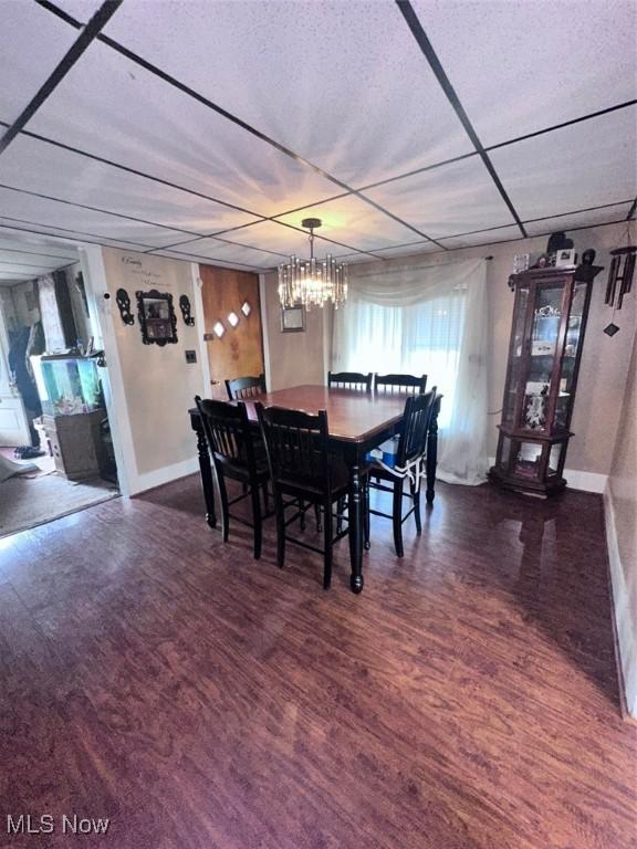 47 Swan St, Geneva, OH 44041 - dining space with wood finished floors, baseboards, and a notable chandelier