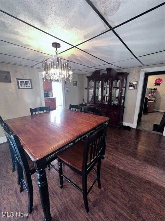 dining room featuring dark wood-type flooring and a textured ceiling