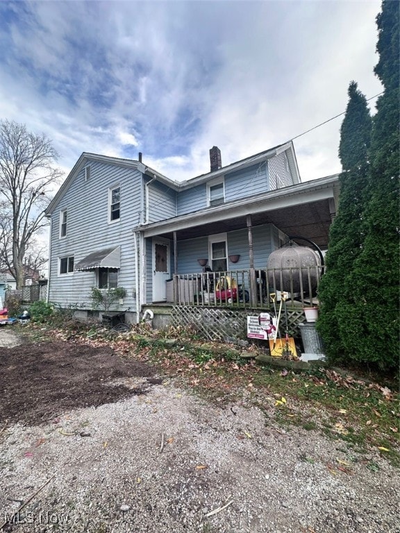 rear view of house with covered porch