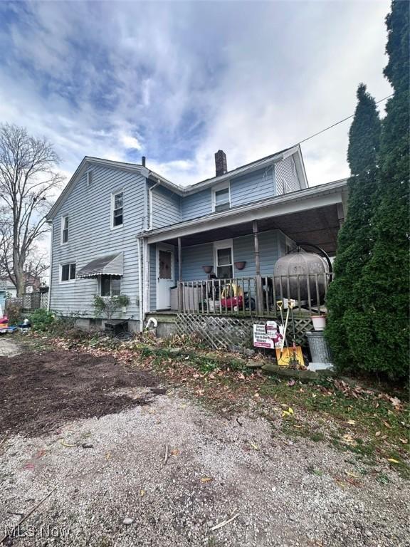 47 Swan St, Geneva, OH 44041 - back of house featuring a chimney and a porch