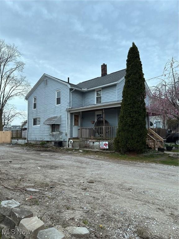 47 Swan St, Geneva, OH 44041 - rear view of house featuring a chimney and fence