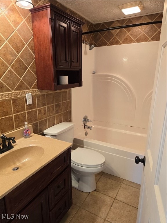 full bathroom featuring tile patterned floors, decorative backsplash, tile walls, a textured ceiling, and  shower combination