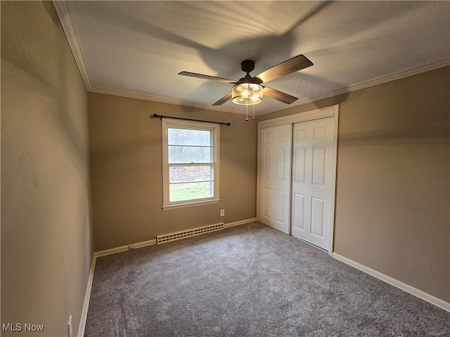 unfurnished bedroom with ceiling fan, a baseboard radiator, crown molding, carpet floors, and a closet