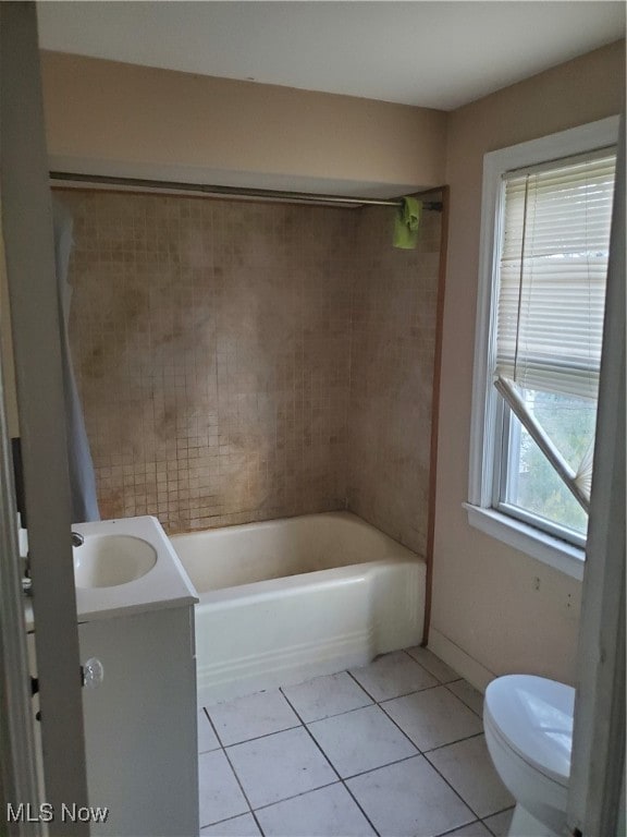 bathroom with vanity, a wealth of natural light, tile patterned floors, and toilet