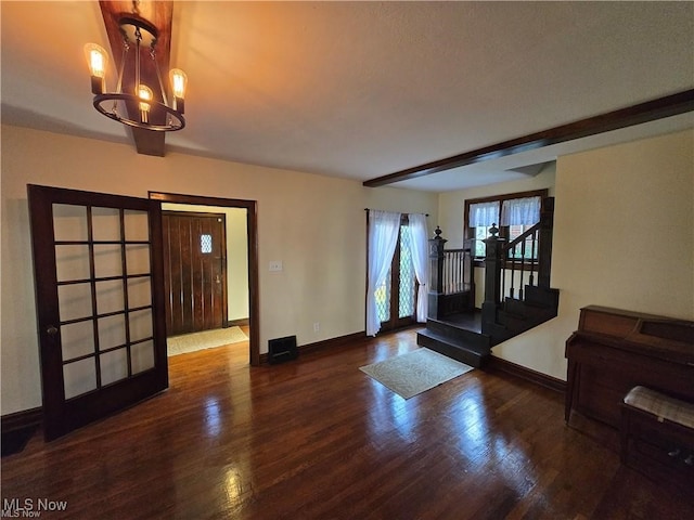 interior space with dark wood-type flooring and a notable chandelier