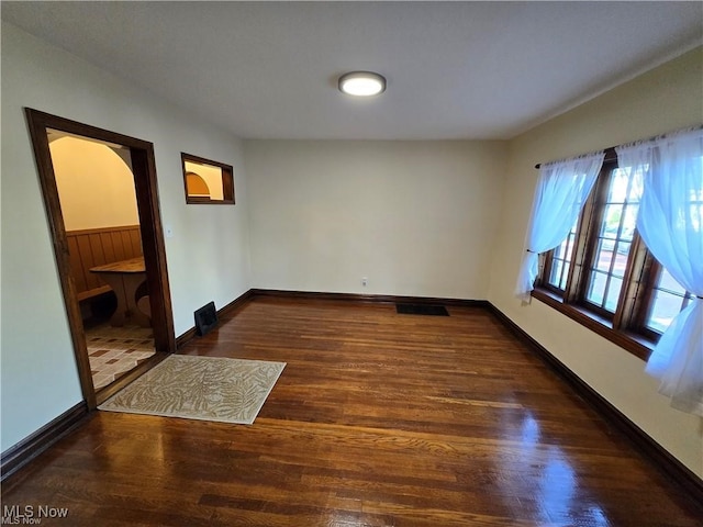 unfurnished room featuring dark hardwood / wood-style flooring