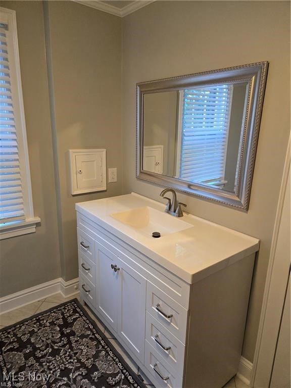 bathroom featuring tile patterned flooring, vanity, and crown molding