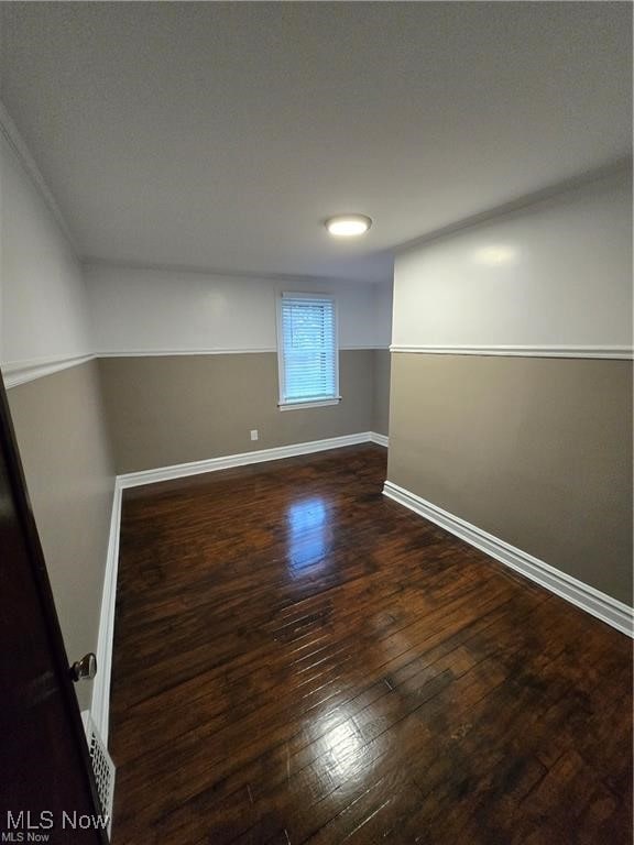 basement featuring dark hardwood / wood-style floors