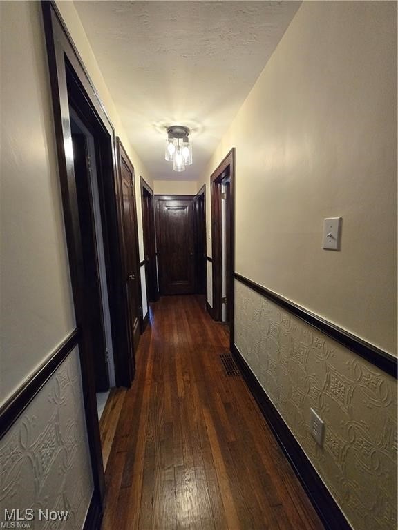 hallway with dark wood-type flooring