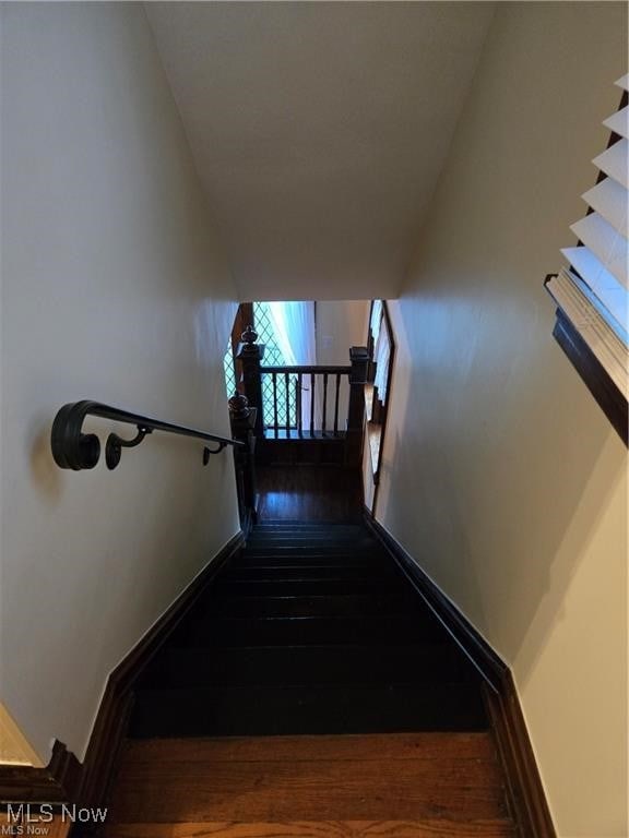 stairway with hardwood / wood-style floors