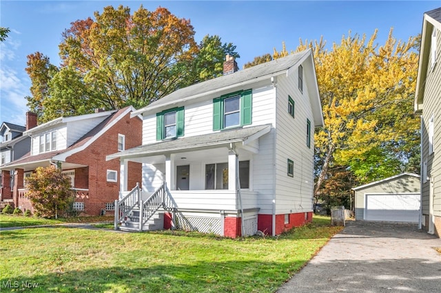 view of front of home with covered porch, a garage, an outdoor structure, and a front lawn