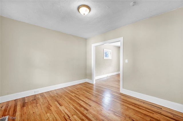 unfurnished room featuring hardwood / wood-style flooring