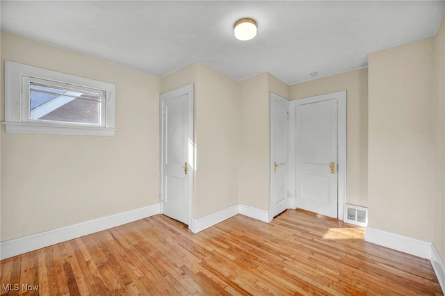 spare room featuring light hardwood / wood-style floors