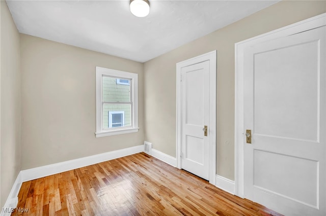 unfurnished bedroom featuring light wood-type flooring