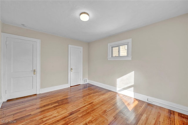 unfurnished room featuring light wood-type flooring