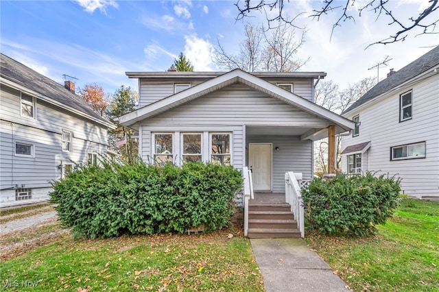 bungalow-style home featuring a front yard