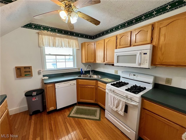 kitchen with a textured ceiling, sink, ceiling fan, light hardwood / wood-style flooring, and white appliances