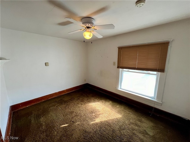 spare room featuring ceiling fan and carpet floors