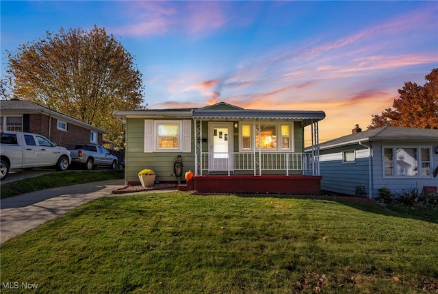 view of front of home with a yard and covered porch