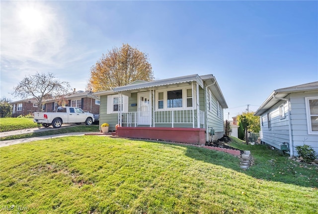 bungalow-style house with a porch and a front lawn