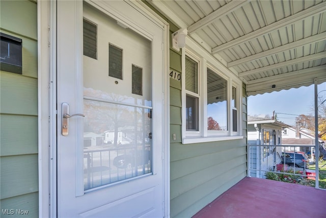 property entrance featuring covered porch