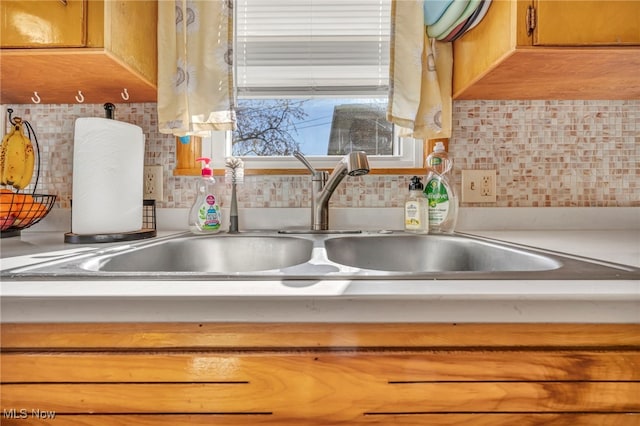 interior details with sink and decorative backsplash