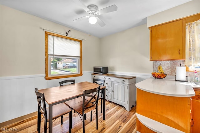 dining room featuring ceiling fan and light hardwood / wood-style flooring