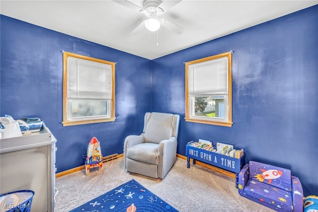 interior space with carpet flooring and ceiling fan