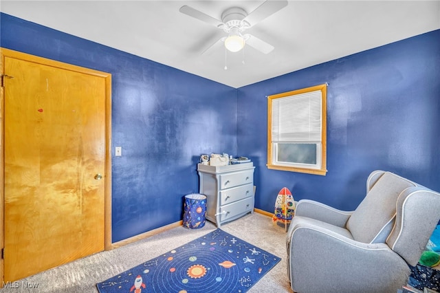 living area featuring carpet flooring and ceiling fan