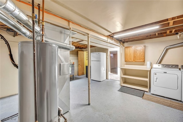 basement with water heater, white fridge, and washer / clothes dryer