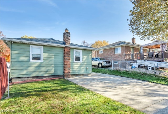 back of house featuring a patio, a lawn, a deck, and a gazebo