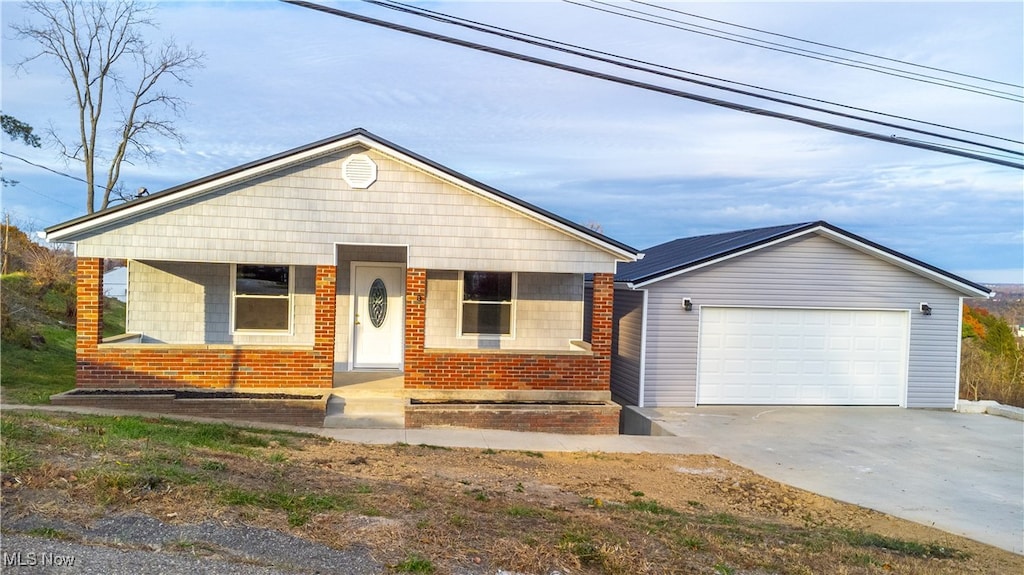 single story home featuring a garage and a porch