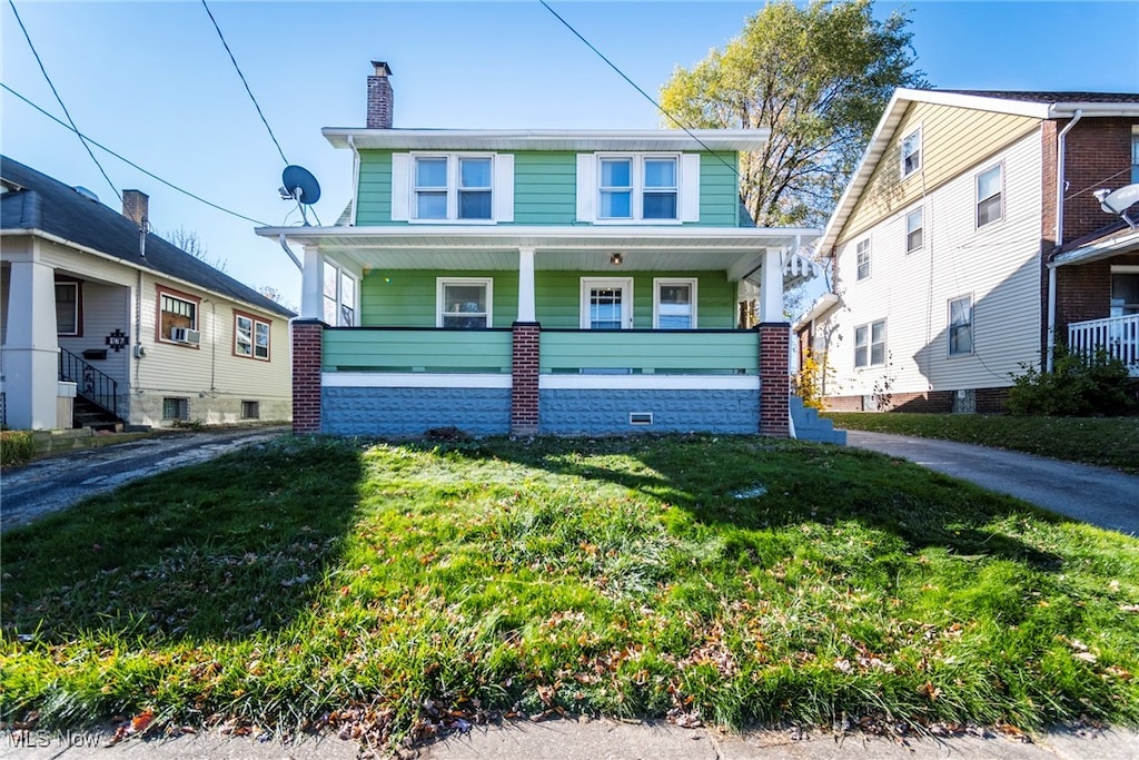 view of front of home featuring a front yard, a porch, and cooling unit