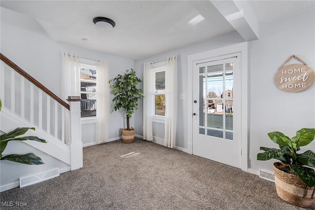 carpeted foyer with plenty of natural light