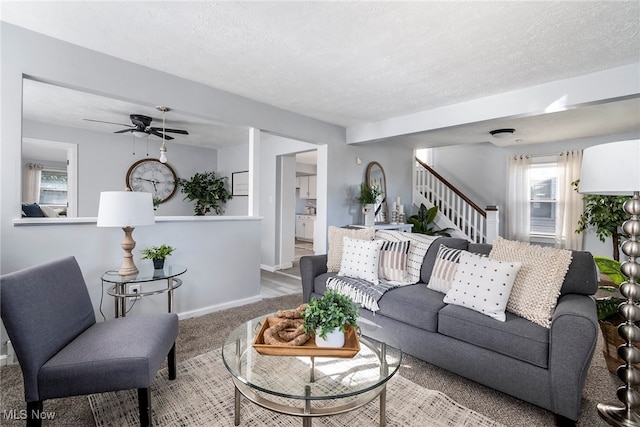 carpeted living room with a textured ceiling and ceiling fan