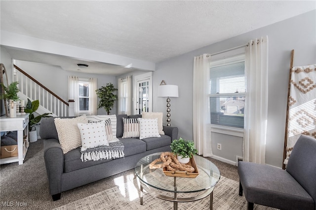 living room with carpet floors and a textured ceiling