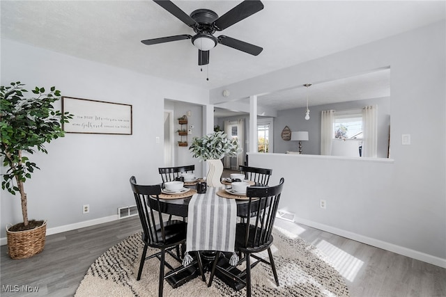 dining area with hardwood / wood-style flooring, ceiling fan, and a textured ceiling