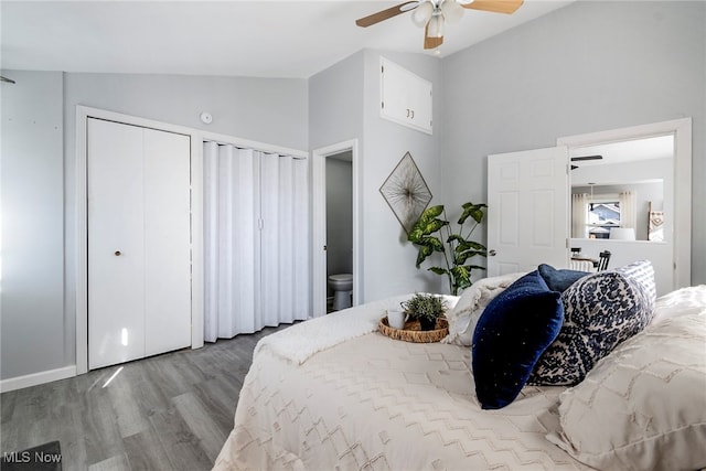 bedroom featuring ceiling fan, vaulted ceiling, wood-type flooring, and ensuite bath