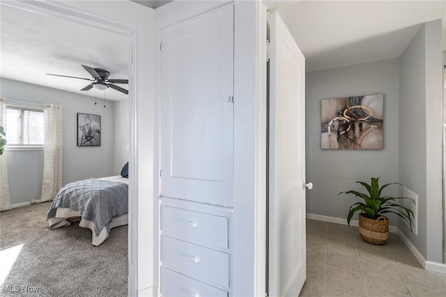 bedroom with ceiling fan and light tile patterned floors