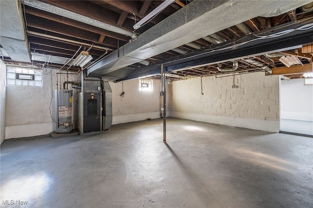 basement featuring heating unit and gas water heater