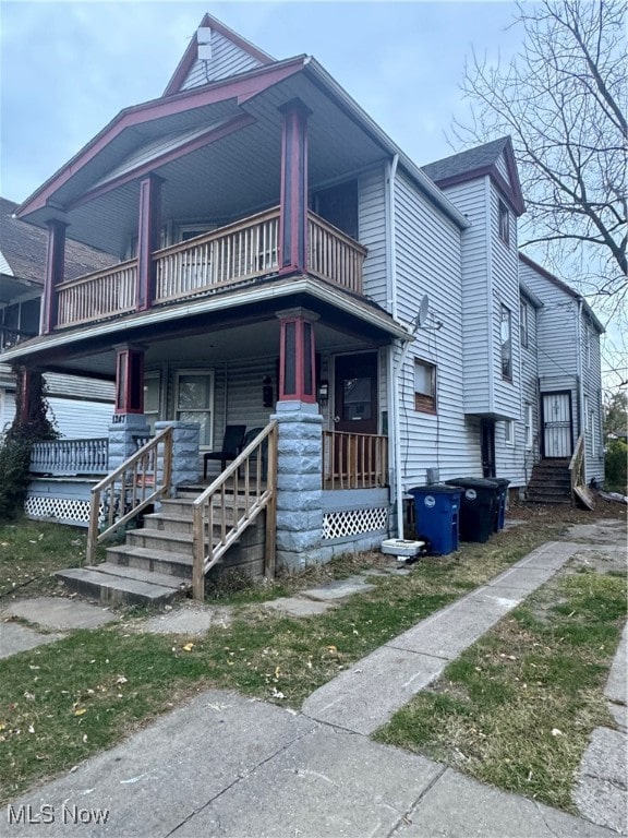 view of front of house featuring a balcony and covered porch