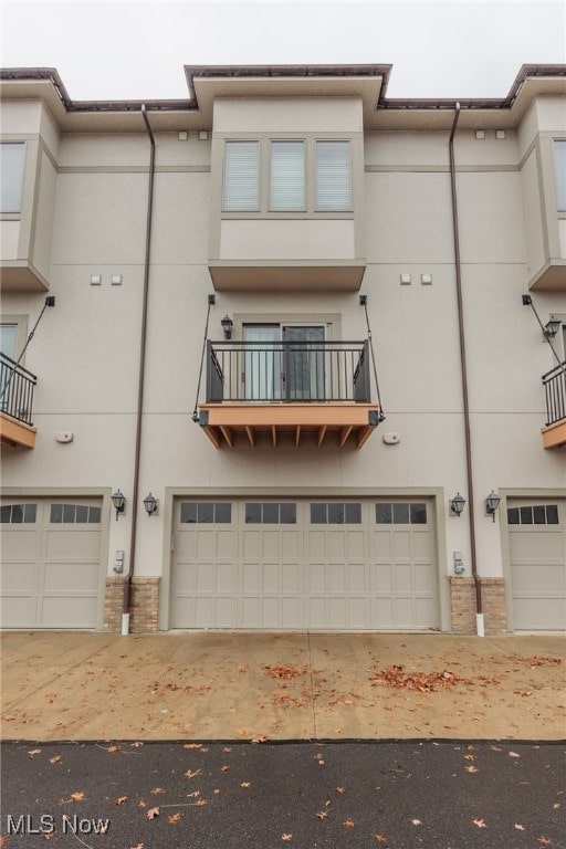 view of front of house with a garage and a balcony