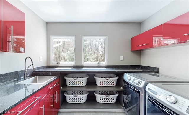 laundry area with cabinets, sink, washer and dryer, and light tile patterned floors