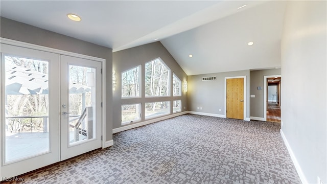 doorway featuring vaulted ceiling, carpet flooring, and french doors