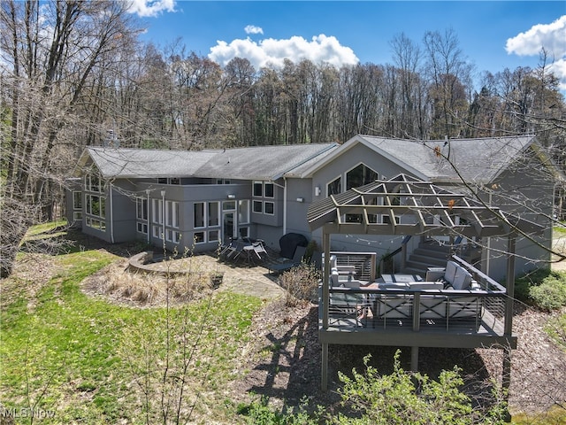 rear view of house with a wooden deck